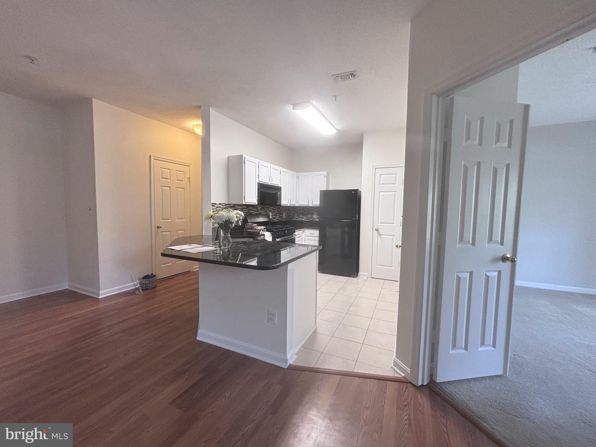 1705 Lake Shore Crest Drive, Unit 23 Reston, VA 20190 - Photo 10 of 45 a kitchen with stainless steel appliances granite countertop a refrigerator and a stove