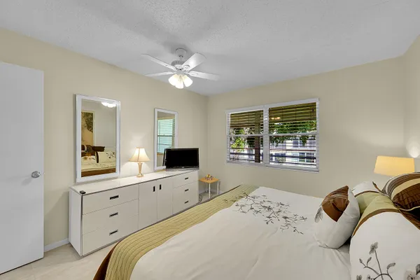 a bedroom with a bed and a mirror