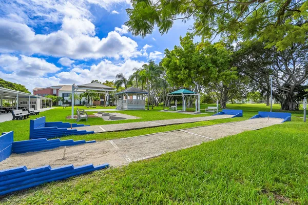 a view of yard with swimming pool and green space