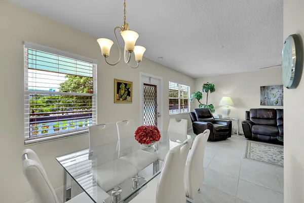 a kitchen with stainless steel appliances granite countertop a refrigerator a stove and a sink with dishwasher