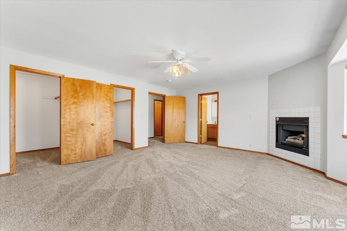 155 Andrew Lane Reno, NV 89521 - Photo 15 of 35 an empty room with chandelier fan and windows