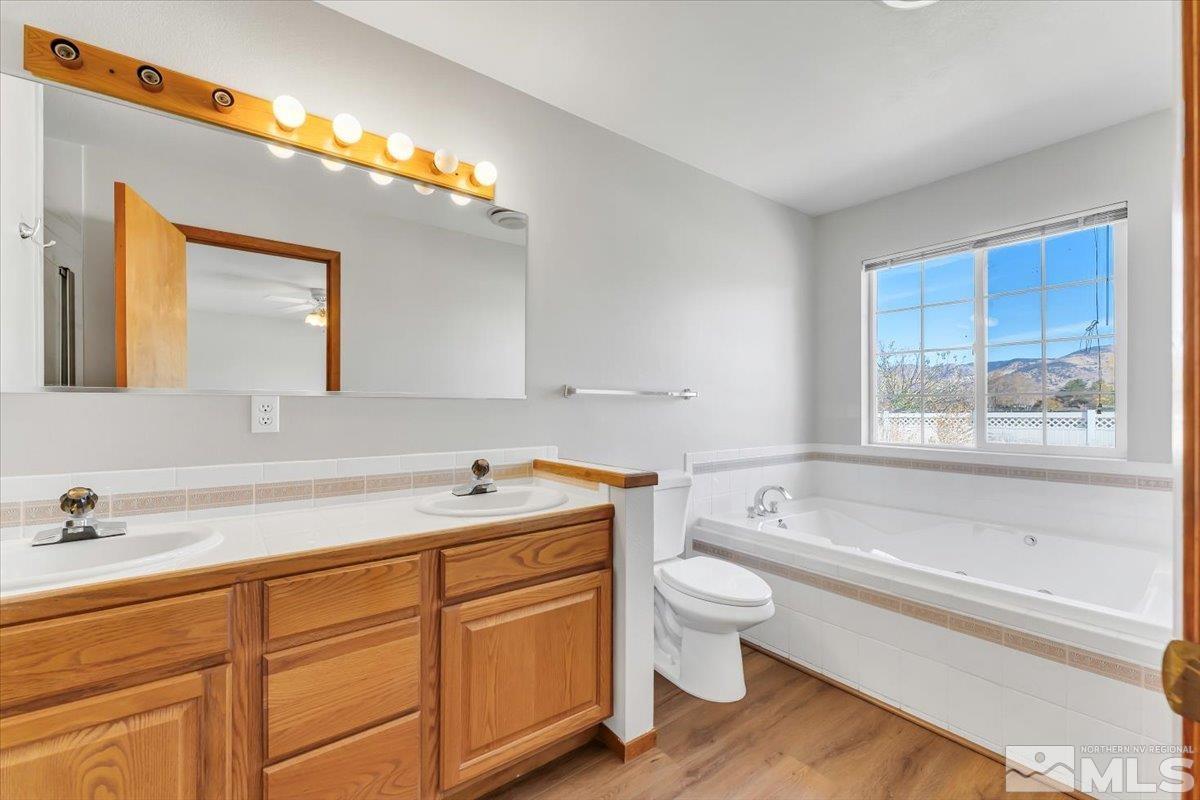 155 Andrew Lane Reno, NV 89521 - Photo 16 of 35 a bathroom with a sink a toilet and bathtub