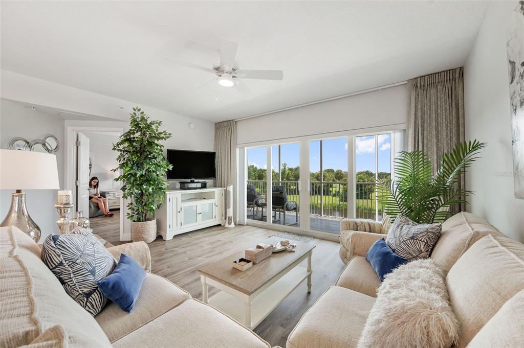 960 Starkey Road, Unit 8206 Largo, FL 33771 - Photo 19 of 71 a living room with furniture a flat screen tv and a large window