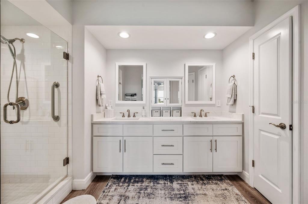 960 Starkey Road, Unit 8206 Largo, FL 33771 - Photo 26 of 71 a spacious bathroom with a double vanity sink a mirror a bathtub and shower