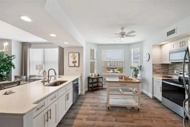 a kitchen with a stove a sink and a refrigerator