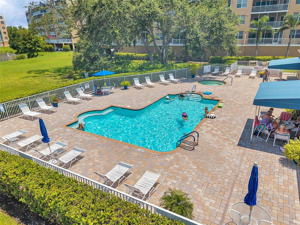 960 Starkey Road, Unit 8206 Largo, FL 33771 - Photo 69 of 71 a view of a swimming pool with a patio and a garden