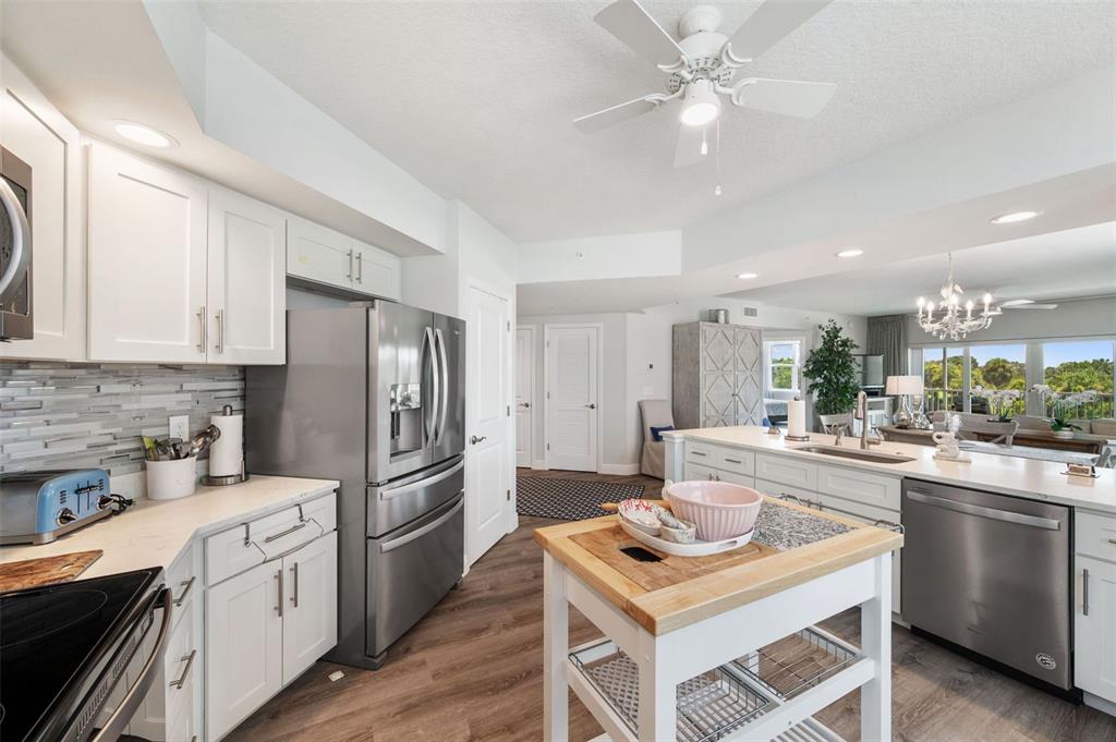 960 Starkey Road, Unit 8206 Largo, FL 33771 - Photo 7 of 71 a kitchen with a stove a sink and a refrigerator