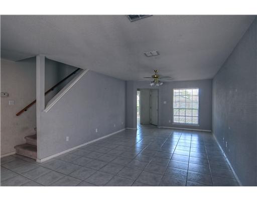 7140 Everhart Road, Unit 3 Corpus Christi, TX 78413 - Photo 3 of 10 a view of an empty room with wooden floor and a window