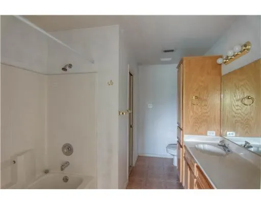 a bathroom with a granite countertop sink a mirror and a shower