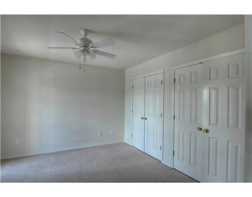 a view of a big room with chandelier fan
