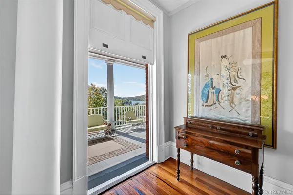 a view of a hallway with wooden floor and a floor to ceiling window