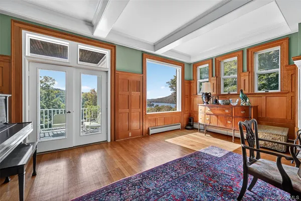 a living room with furniture and large windows