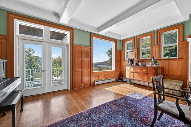 a living room with furniture and large windows