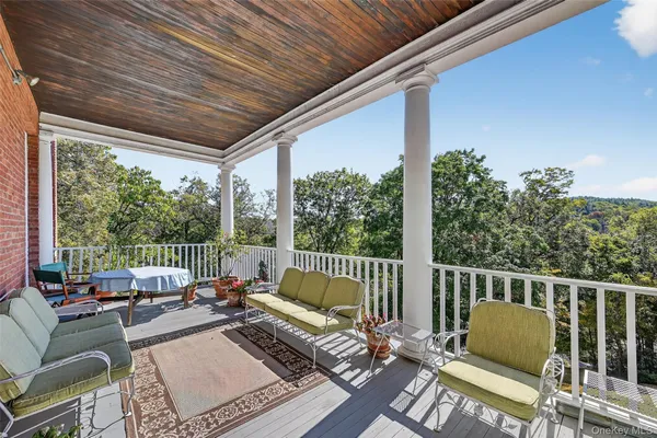 a balcony with furniture and a garden