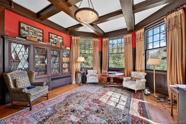 a living room with furniture and large windows