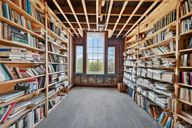 a room with bookshelf and a book shelf
