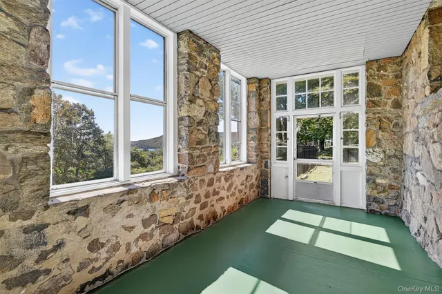a view of balcony with a large window and swing