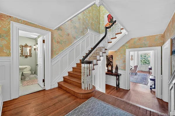 a view of entryway and hall with wooden floor