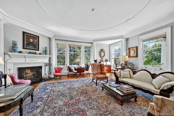 a living room with furniture fireplace and a large window