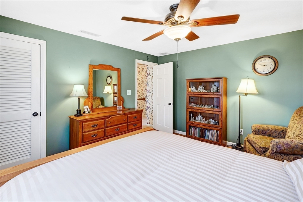 27 West Colonial Road Wilbraham, MA 01095 - Photo 26 of 42 a bedroom with a bed and a chandelier