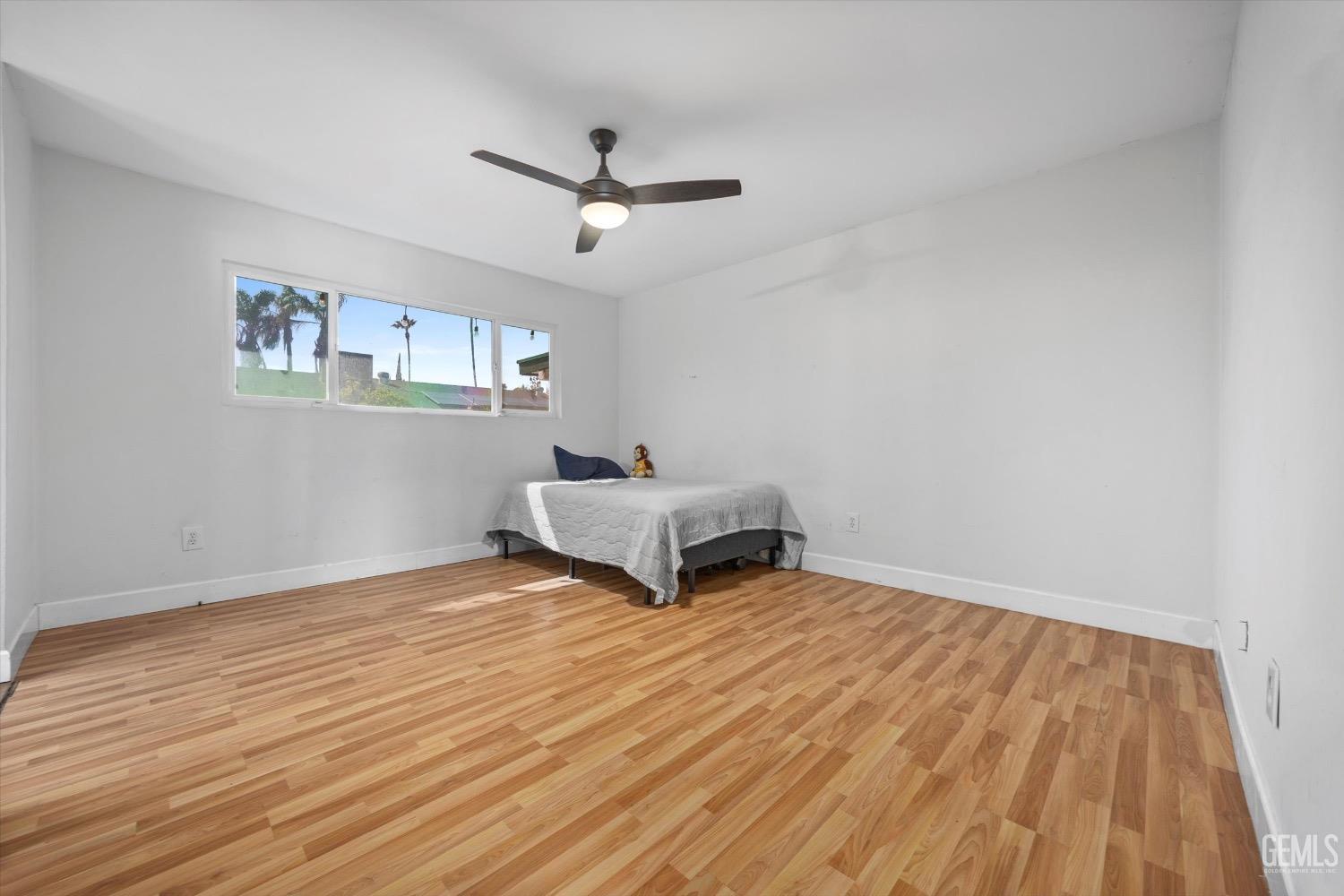 Undisclosed Address Bakersfield, CA 93309 - Photo 20 of 36 a living room with hard wood floors and white walls