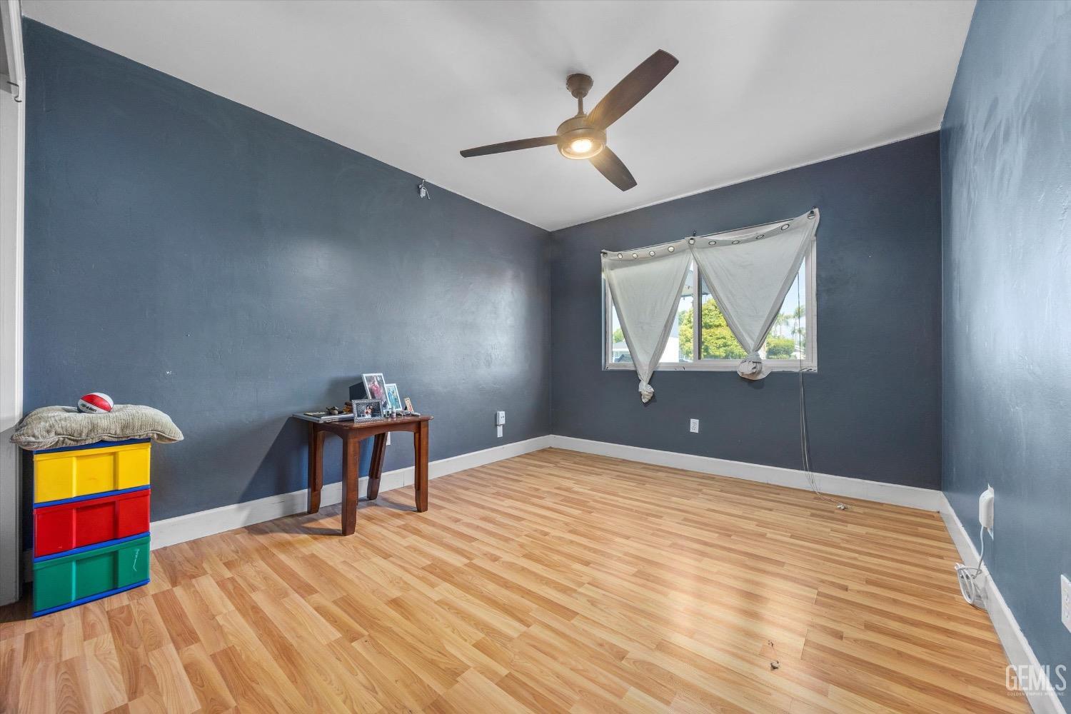 Undisclosed Address Bakersfield, CA 93309 - Photo 24 of 36 a bedroom with a bed and a painting on the wall