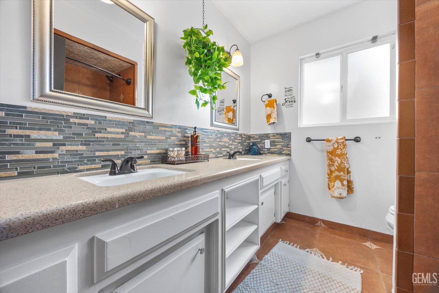 Undisclosed Address Bakersfield, CA 93309 - Photo 26 of 36 a bathroom with a sink and a mirror