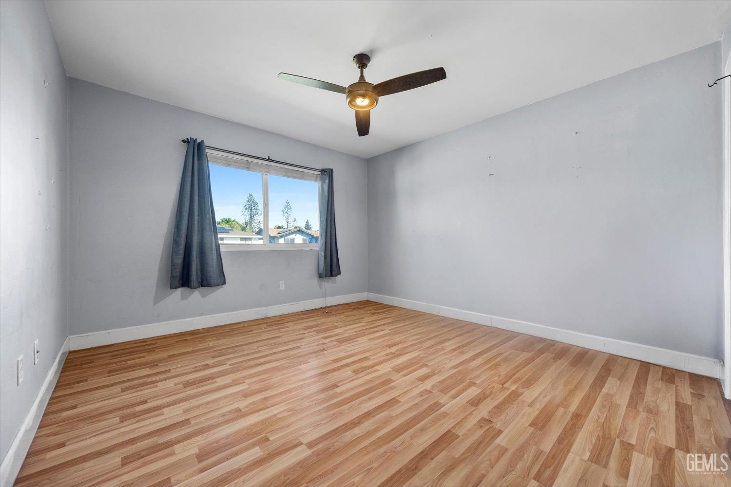 Undisclosed Address Bakersfield, CA 93309 - Photo 28 of 36 a view of empty room with wooden floor and fan