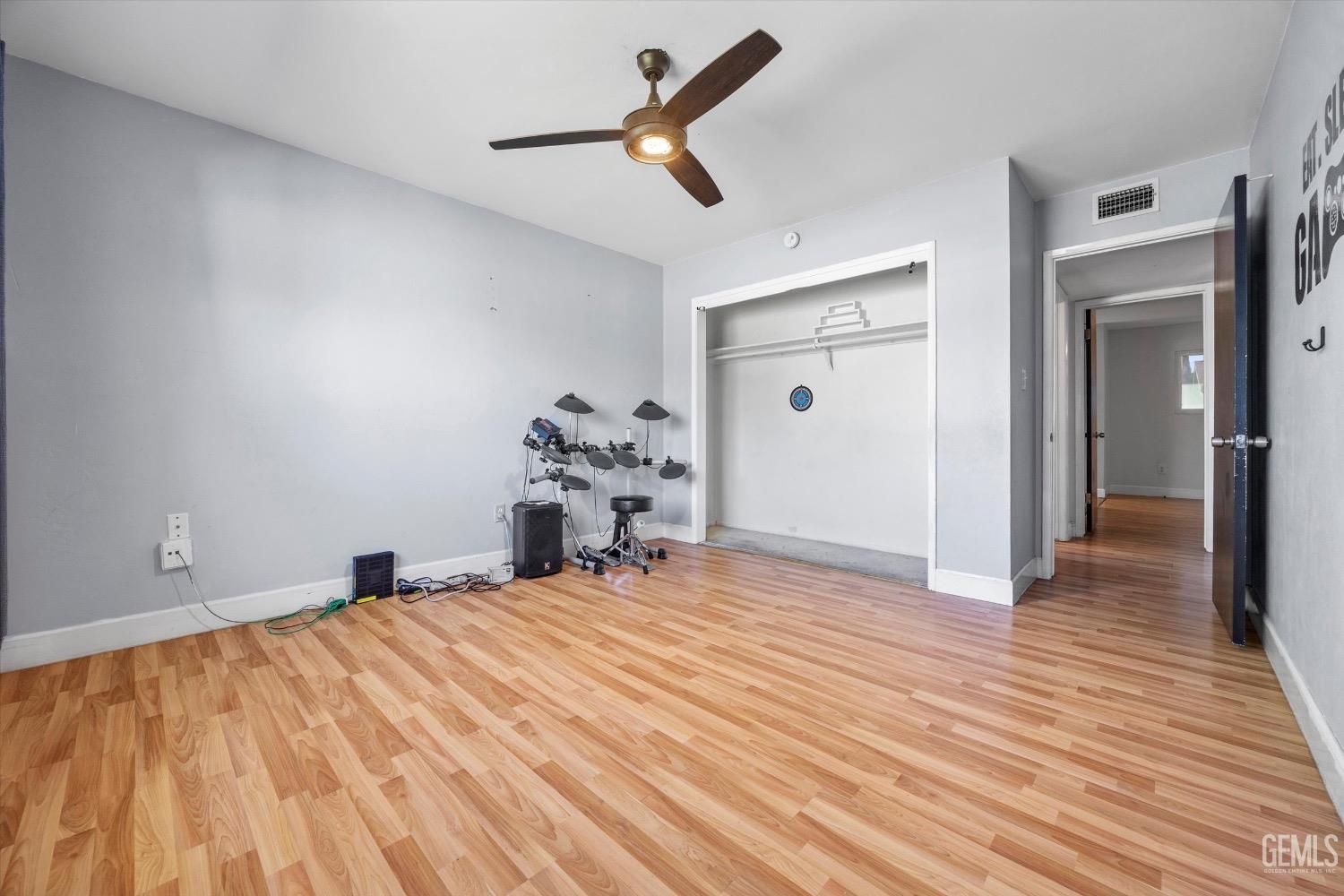 Undisclosed Address Bakersfield, CA 93309 - Photo 29 of 36 a bedroom with a bed and wooden floor