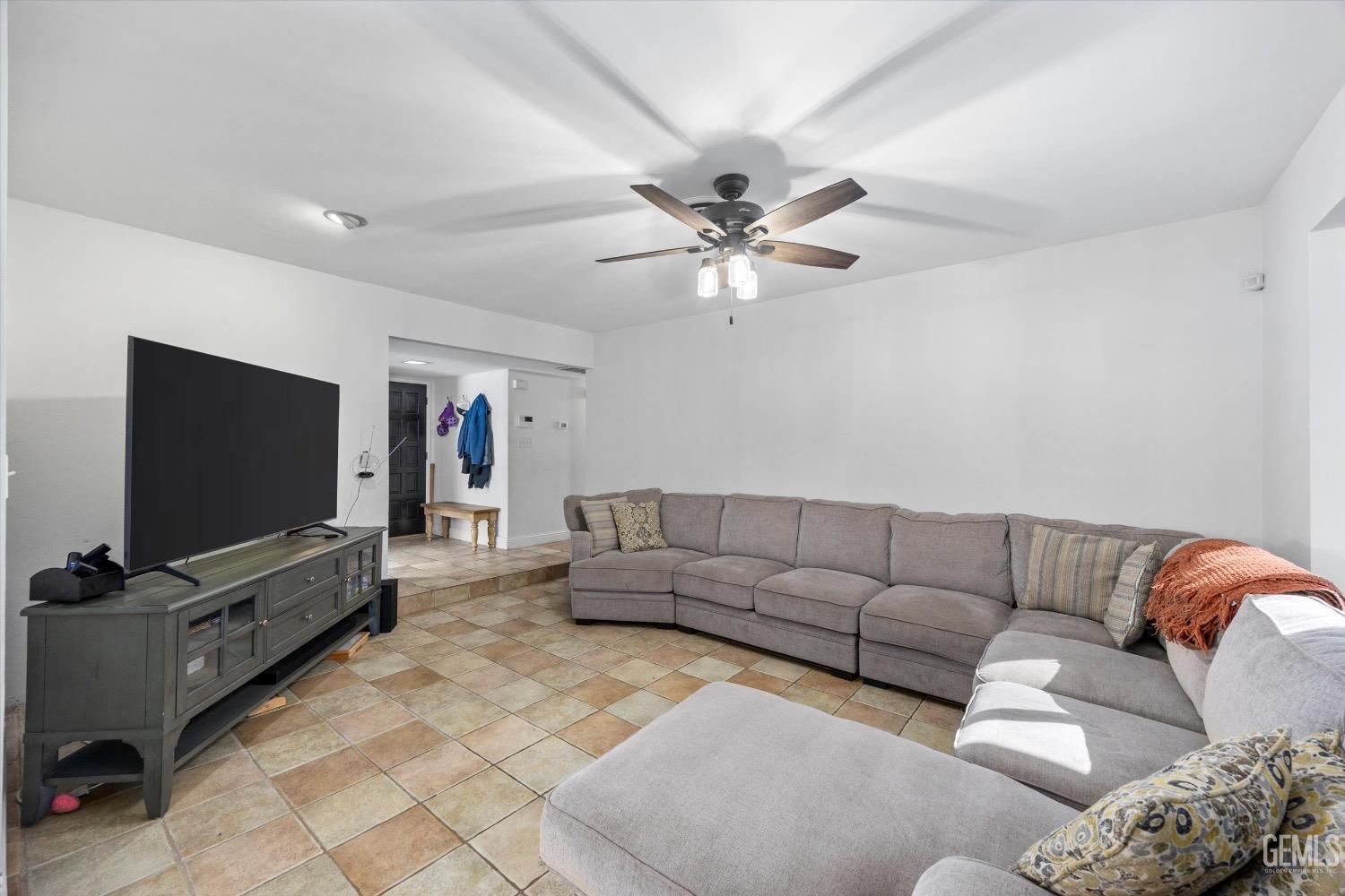 Undisclosed Address Bakersfield, CA 93309 - Photo 8 of 36 a living room with furniture and a flat screen tv