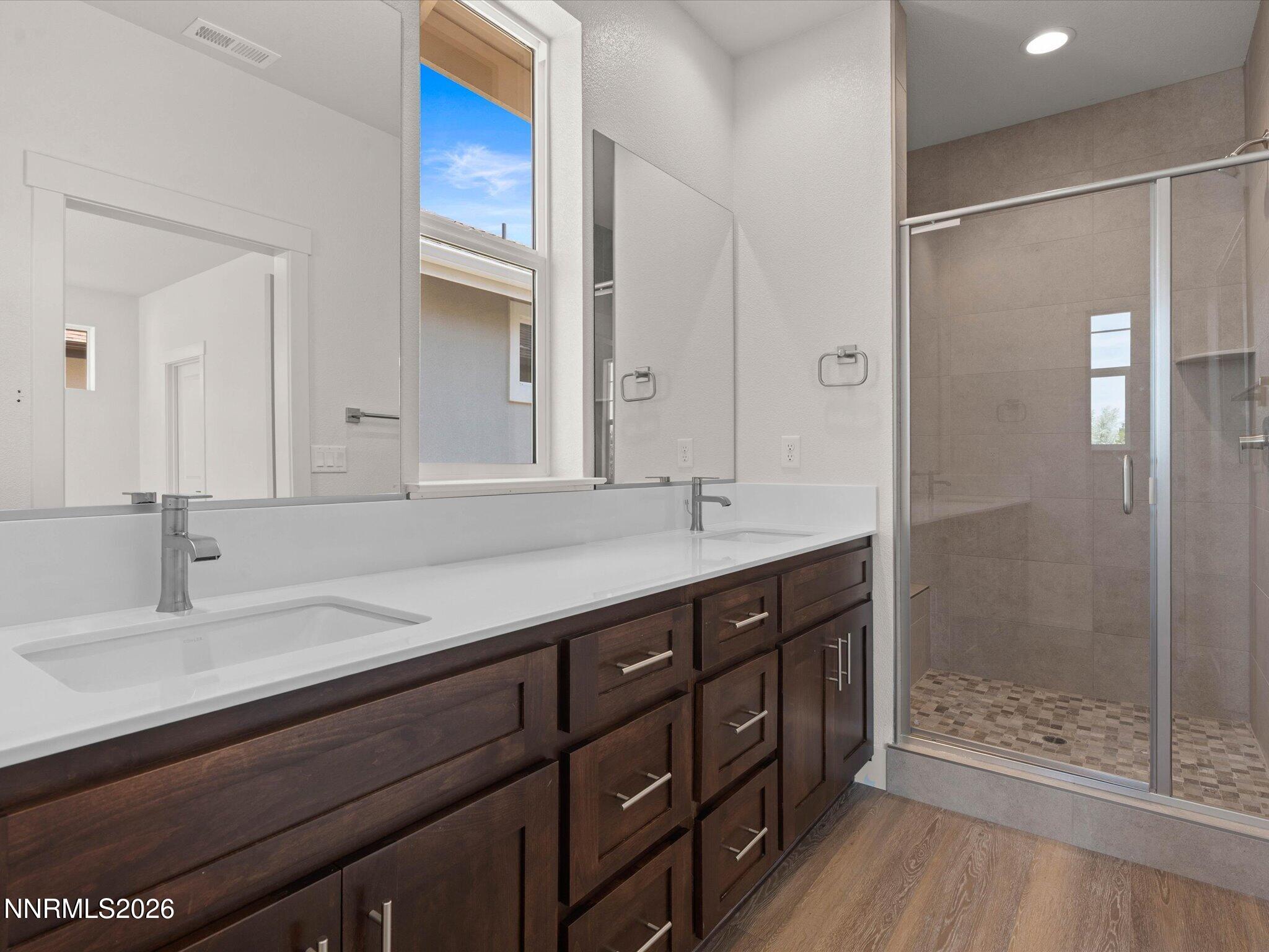 1371 Vine Gate Road, Unit HOMESITE 49 Carson City, NV 89701 - Photo 11 of 24 a bathroom with a double vanity sink mirror and shower