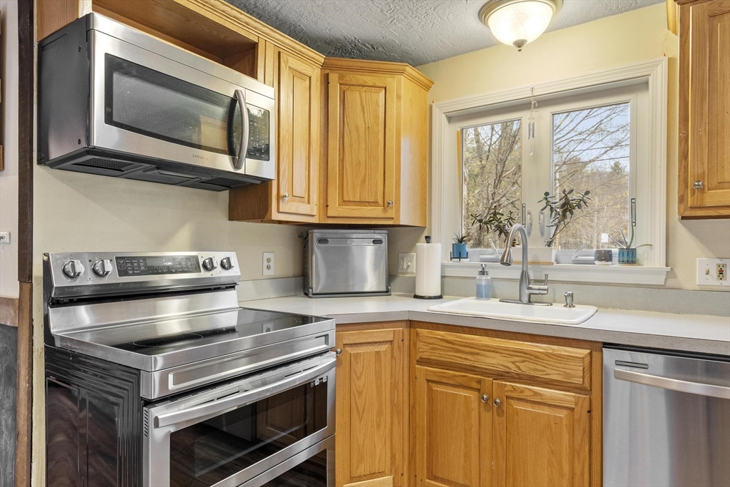 101 Williams Road Ashburnham, MA 01430 - Photo 16 of 42 a kitchen with granite countertop cabinets stainless steel appliances and a window