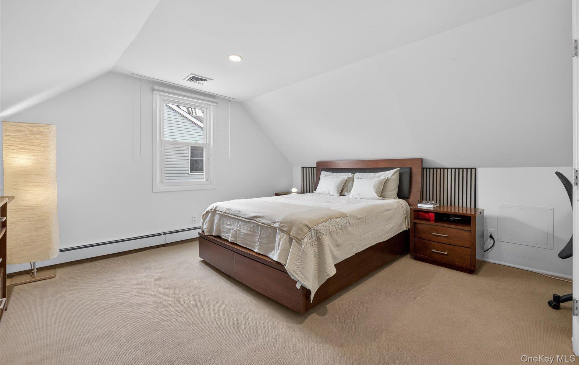 28 Harbor Road Port Washington, NY 11050 - Photo 12 of 22 a spacious bedroom with a bed and a window