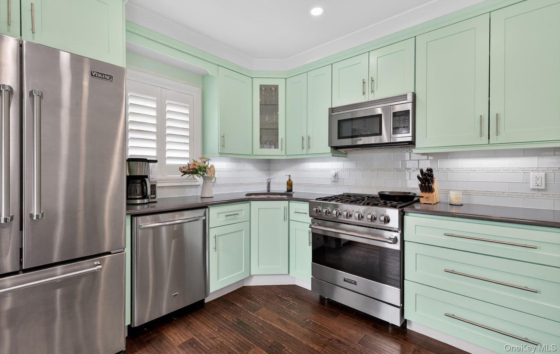 28 Harbor Road Port Washington, NY 11050 - Photo 8 of 22 a kitchen with stainless steel appliances granite countertop a stove a sink and a microwave