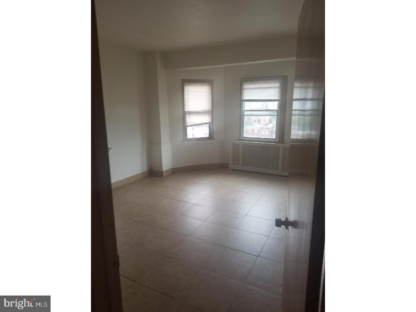 1321 Spruce Street, Unit 1E Philadelphia, PA 19107 - Photo 18 of 22 a view of an empty room with a window