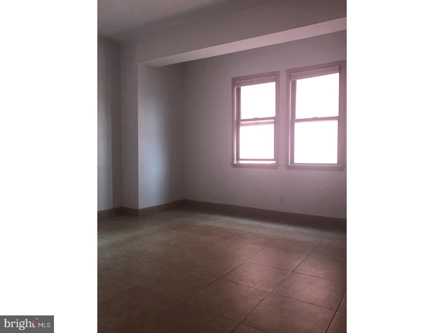 1321 Spruce Street, Unit 1E Philadelphia, PA 19107 - Photo 5 of 22 a view of an empty room with a window