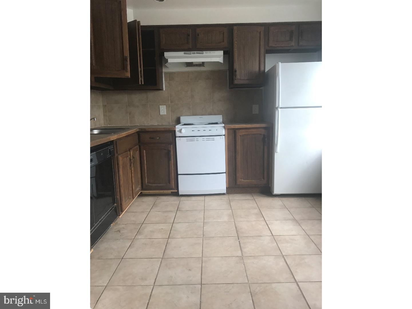 1321 Spruce Street, Unit 1E Philadelphia, PA 19107 - Photo 6 of 22 a kitchen with a sink and a refrigerator