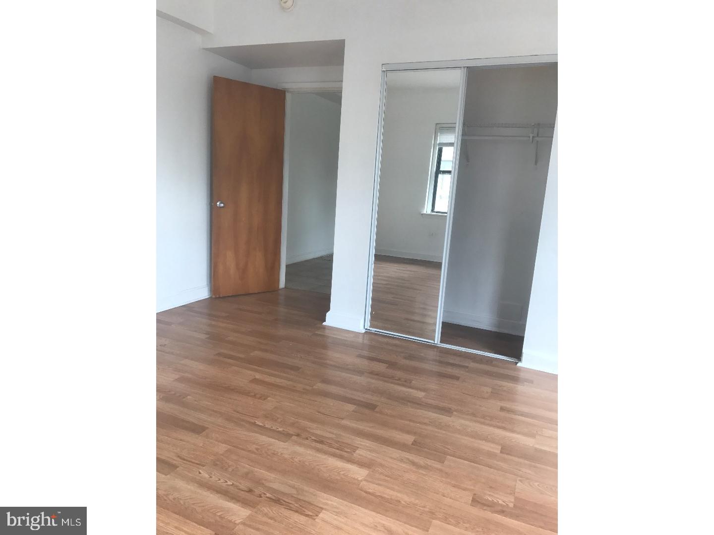 1321 Spruce Street, Unit 1E Philadelphia, PA 19107 - Photo 10 of 22 a view of a hallway with wooden floor