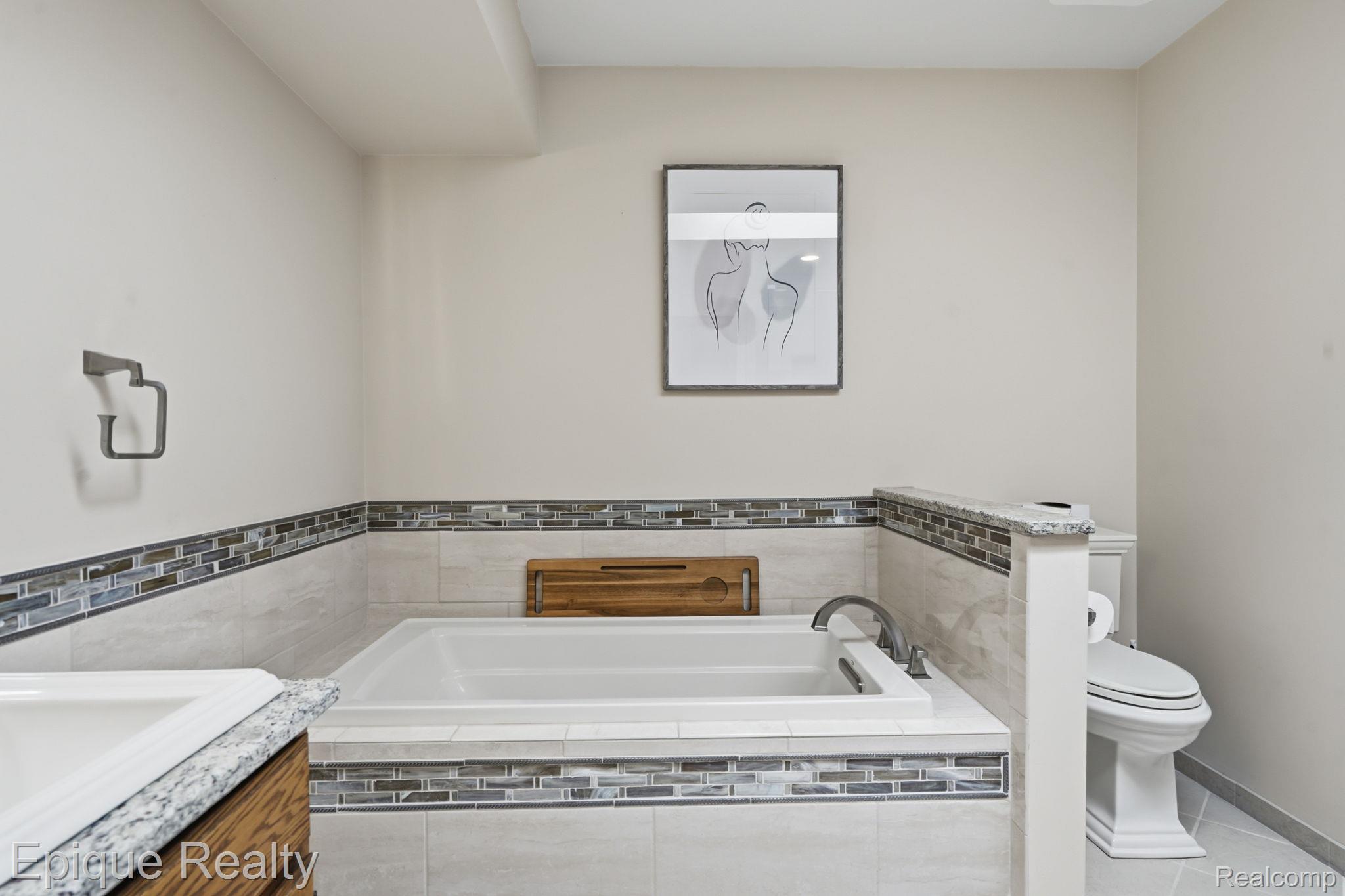 6607 Ridgeview Drive Clarkston, MI 48346 - Photo 23 of 25 Full bathroom with a garden tub, light tile patterned floors, and vanity