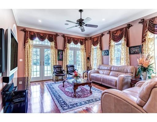 11 Bramble Lane Sharon, MA 02067 - Photo 11 of 30 a living room with furniture a large window and a chandelier
