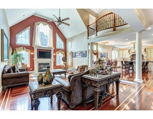 a living room with furniture a fireplace and a chandelier