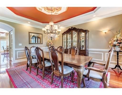 a dining room with furniture a chandelier and wooden floor