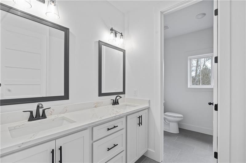 301 Roy Morgan Road Carrollton, GA 30116 - Photo 17 of 35 a bathroom with 2 sink toilet and a mirror