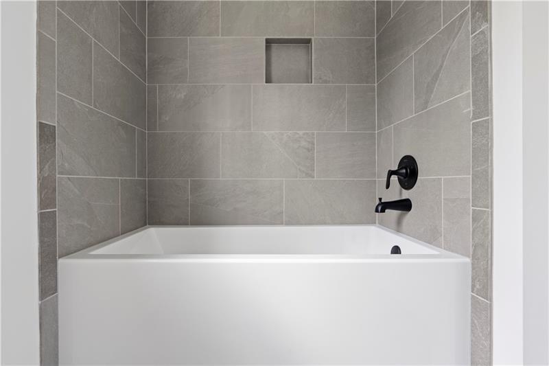 301 Roy Morgan Road Carrollton, GA 30116 - Photo 18 of 35 a white bath tub sitting in a bathroom