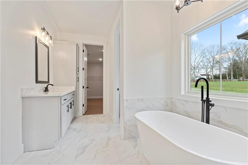 301 Roy Morgan Road Carrollton, GA 30116 - Photo 25 of 35 a spacious bathroom with a tub sink and mirror