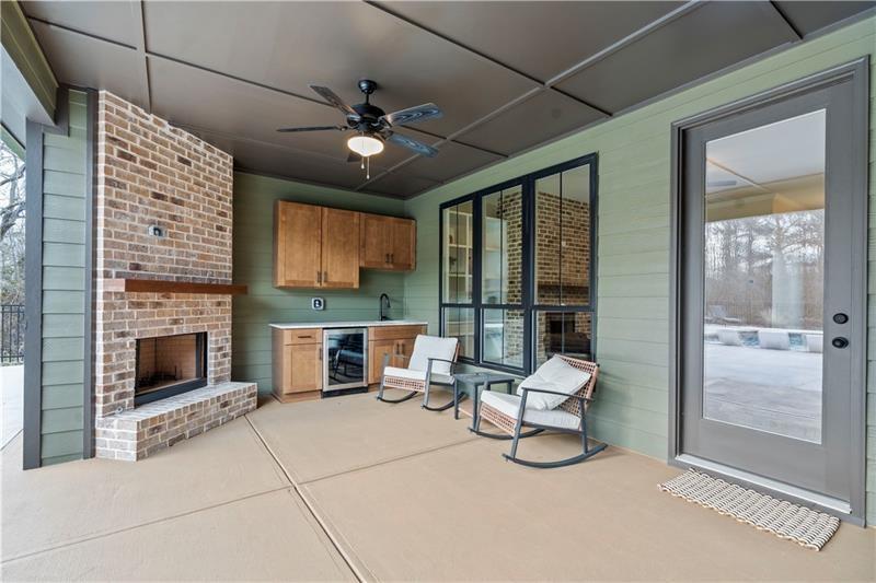 301 Roy Morgan Road Carrollton, GA 30116 - Photo 31 of 35 a living room with furniture a fireplace and a flat screen tv