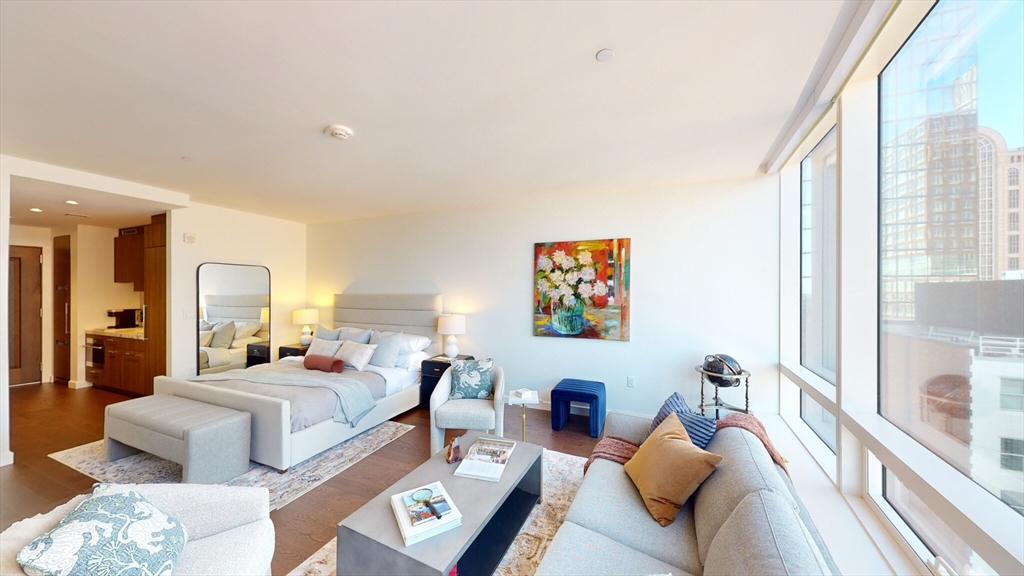 40 Trinity Place, Unit 1503 Boston, MA 02116 - Photo 2 of 14 a bedroom with furniture and a large window