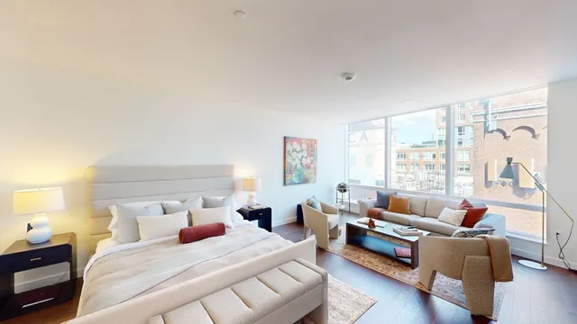 a bedroom with furniture and a large window