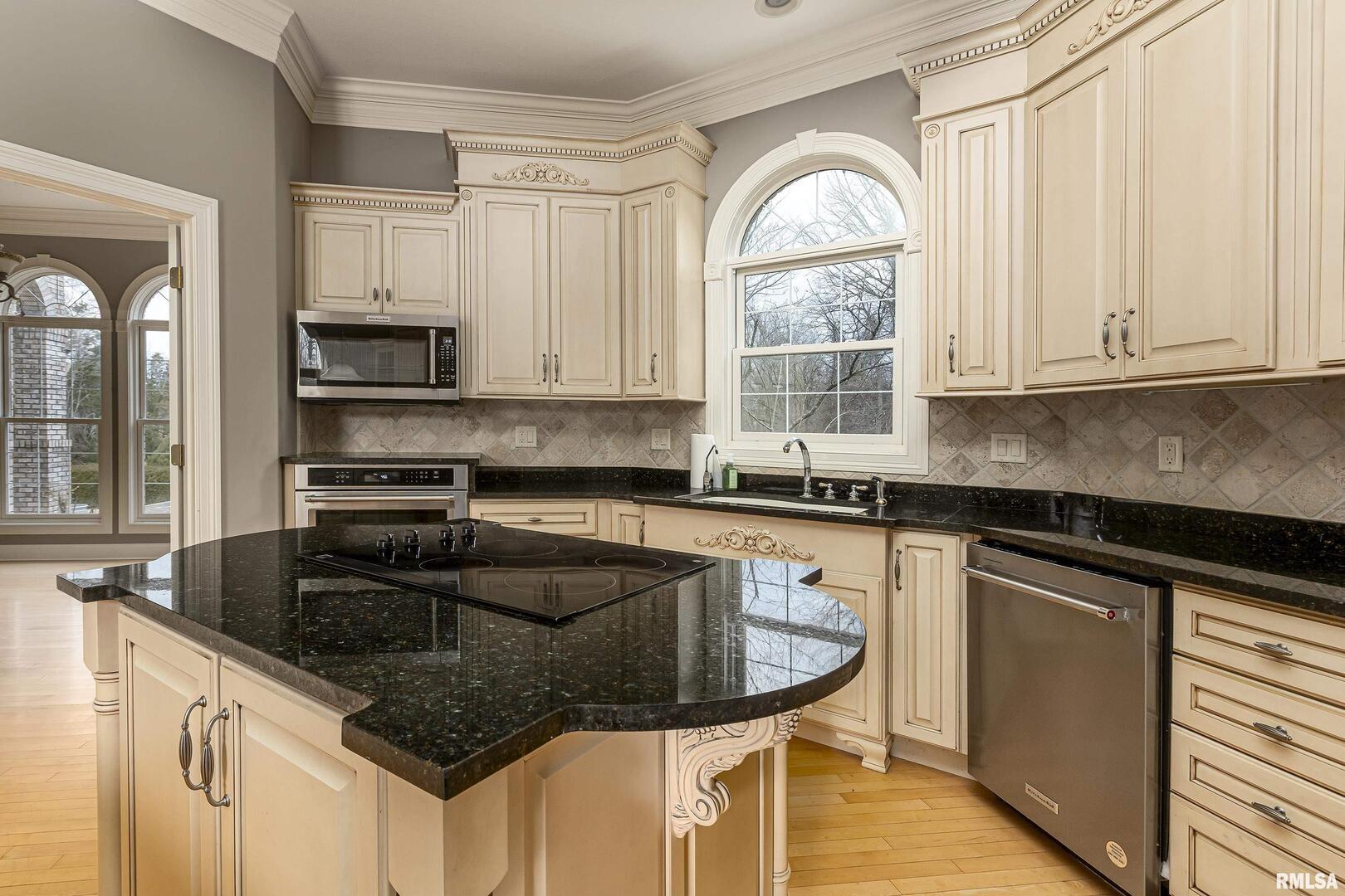 3115 West Striegel Road Carbondale, IL 62901 - Photo 23 of 54 a kitchen with granite countertop a sink stainless steel appliances and cabinets