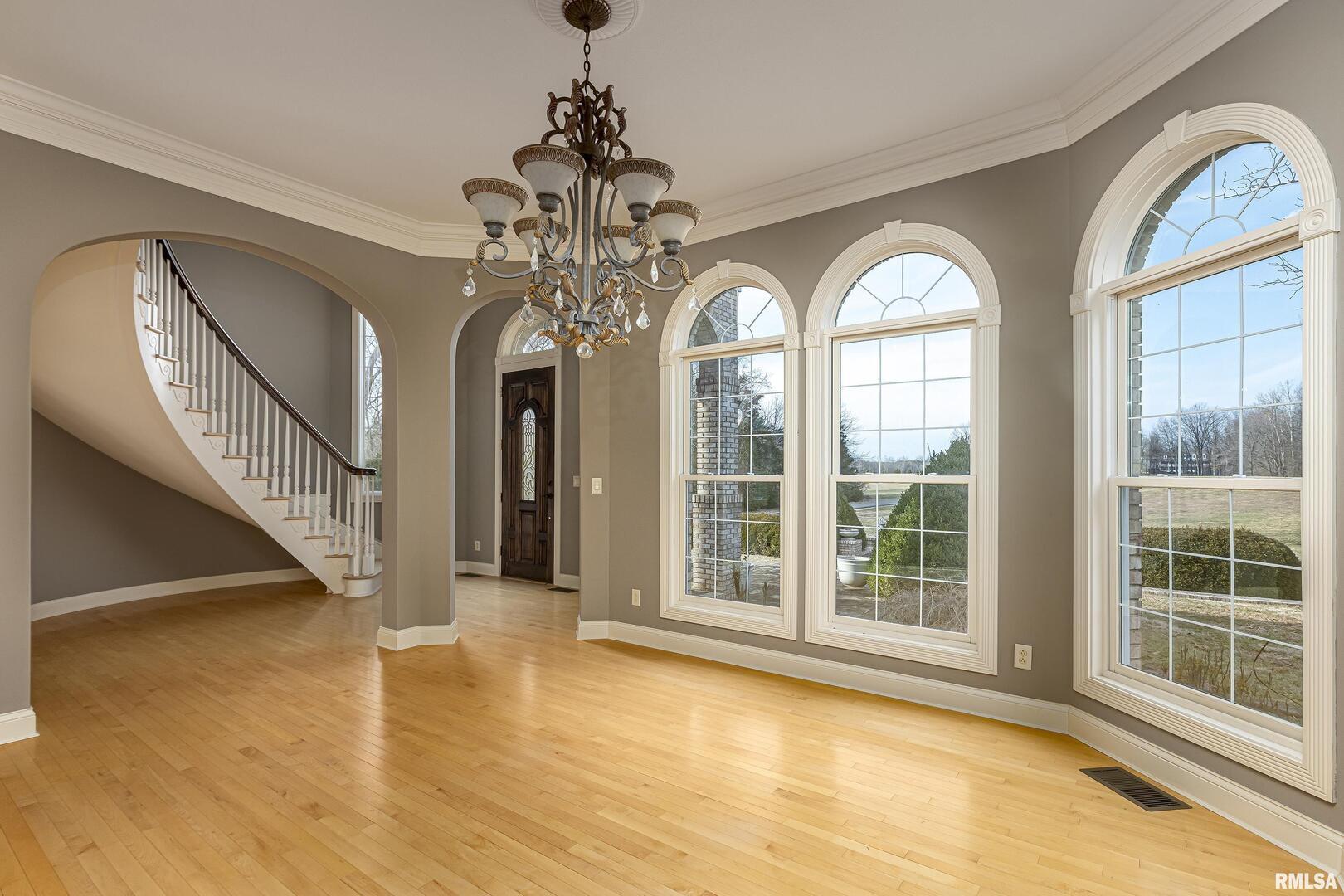 3115 West Striegel Road Carbondale, IL 62901 - Photo 4 of 54 a view of a livingroom with wooden floor staircase and windows